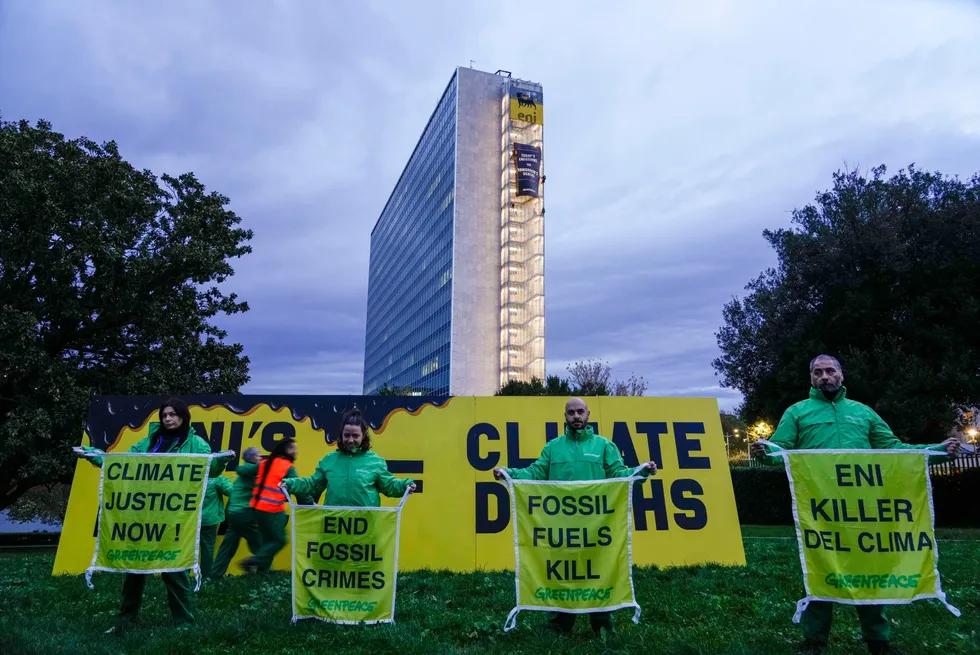 Greenpeace activists unroll banners close to Eni's headquarters in Italy last year.