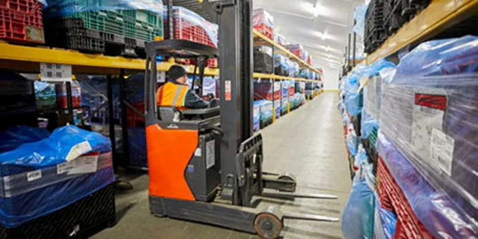 Forklift operating in cold storage warehouse.
