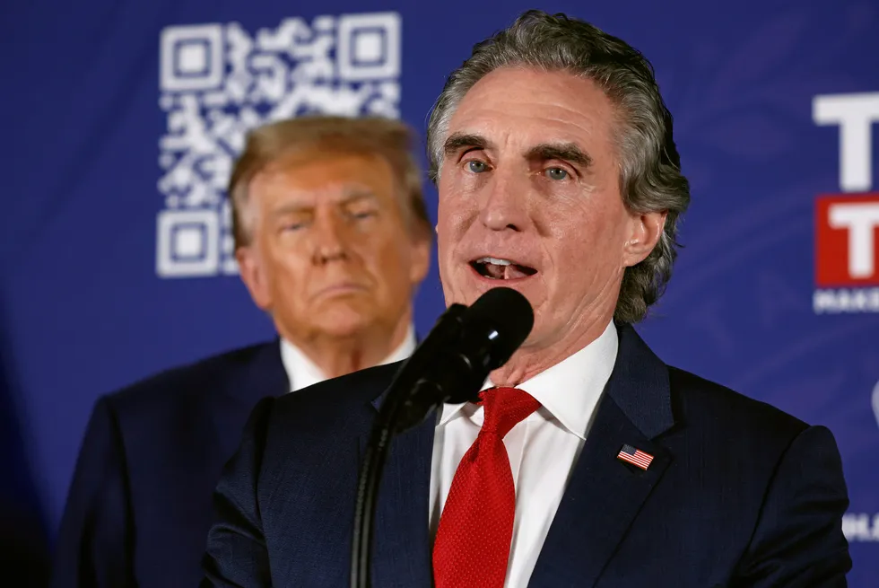 Interior secretary pick Doug Burgum is watched by Donald Trump.