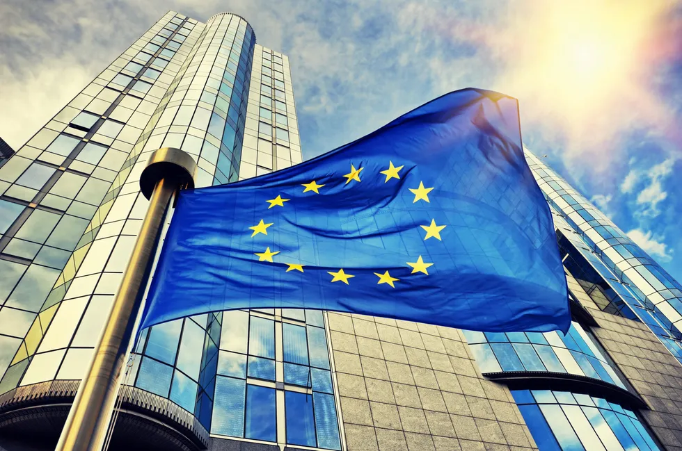 EU flag waving in front of European Parliament building. Brussels, Belgium.