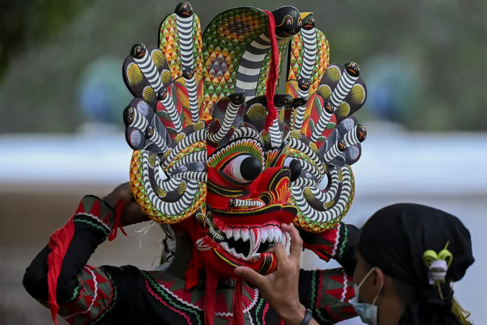 Celebration: a traditional dancer prepares to perform during the Esala Perahera festival in front of the historic Ruhunu Maha Kataragama Hindu temple in Sri Lanka