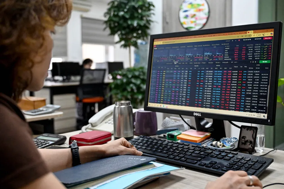 A woman looks at an electronic stockboard on her computer at a trading company in Hanoi on Tuesday.