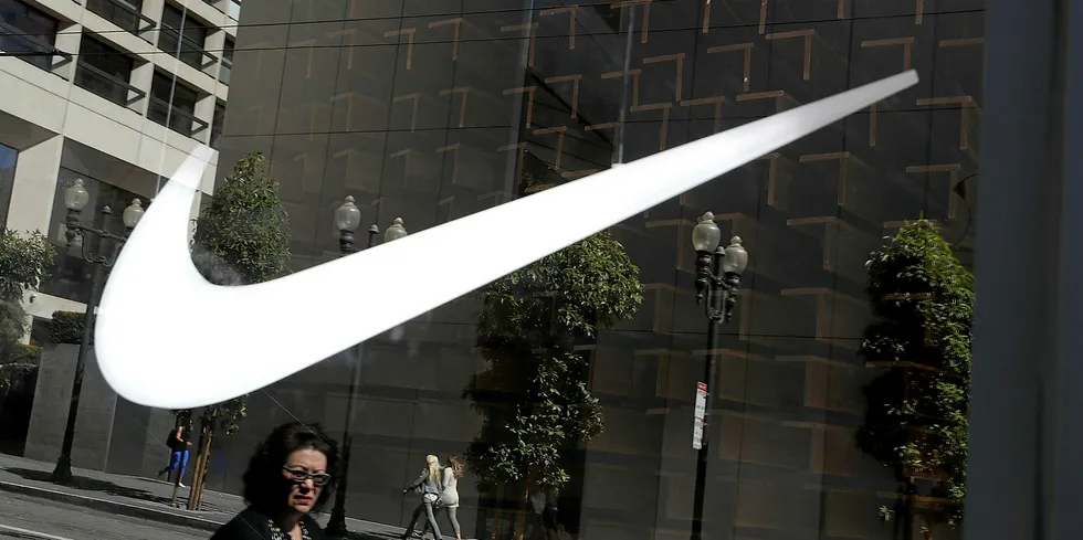 The Nike logo is displayed in a window at a Nike Store.
