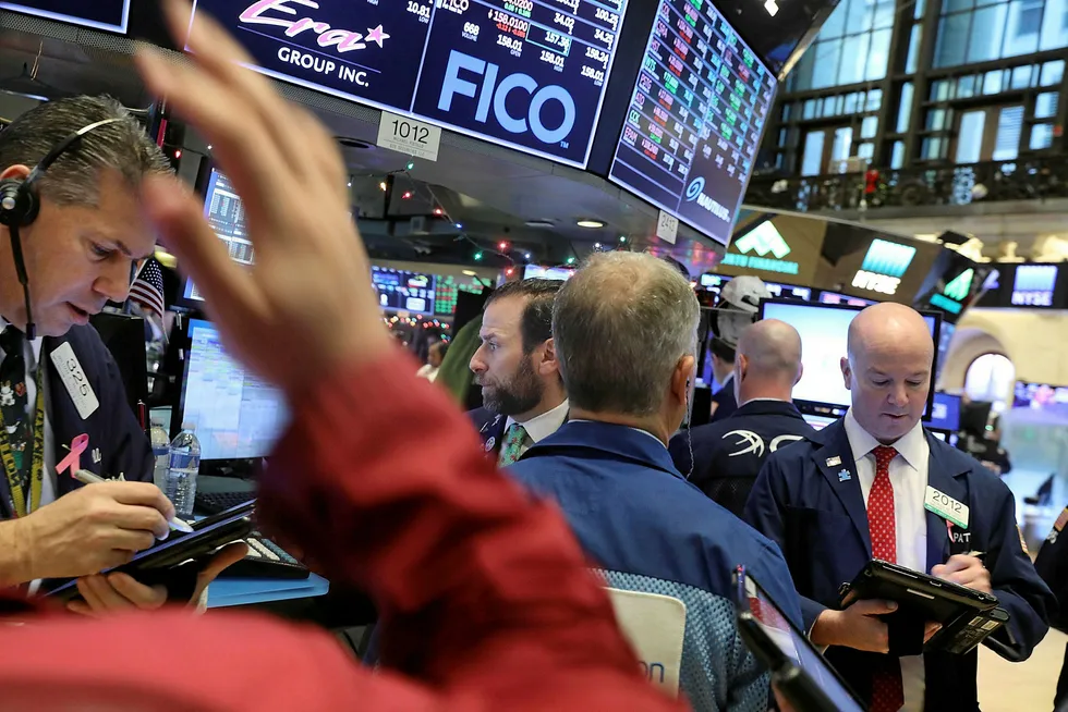 Oil falls: traders work on the floor of the New York Stock Exchange