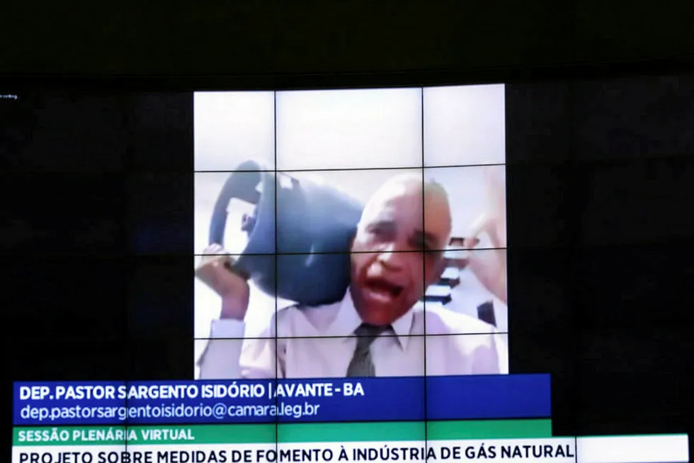 Burden: Brazilian lawmaker Deputy Sargento Isidorio holds an LPG bottle during a congressional debate on gas sector reforms
