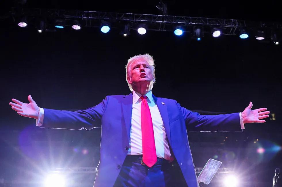 Republican presidential nominee and former US president Donald Trump reacts during a campaign rally in Michigan.