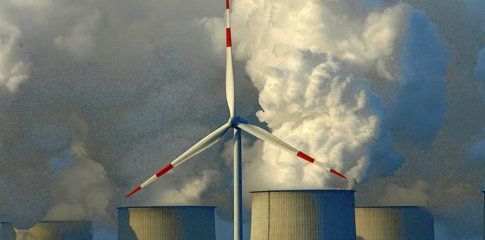 Wind turbine in front of the lignite-fired power plant in Jaenschwalde, Germany