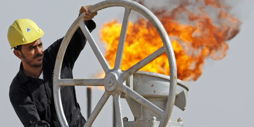 An Iraqi worker operates valves at the Nahran Omar oil refinery near the city of Basra, Iraq
