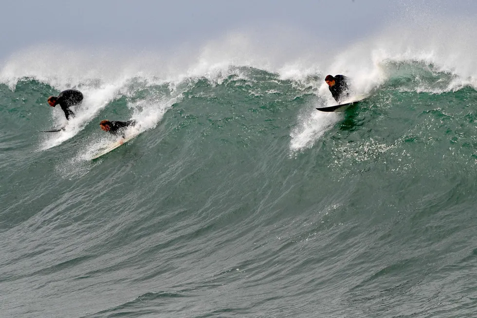 Surfers paddle for a wave: in Australia