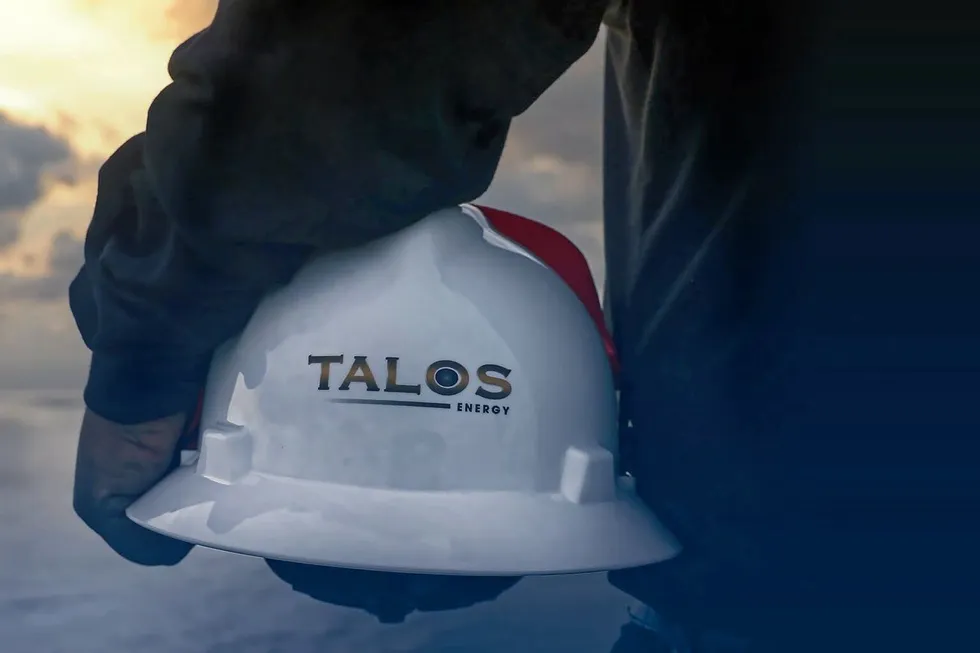 Talos Energy worker holding hat.