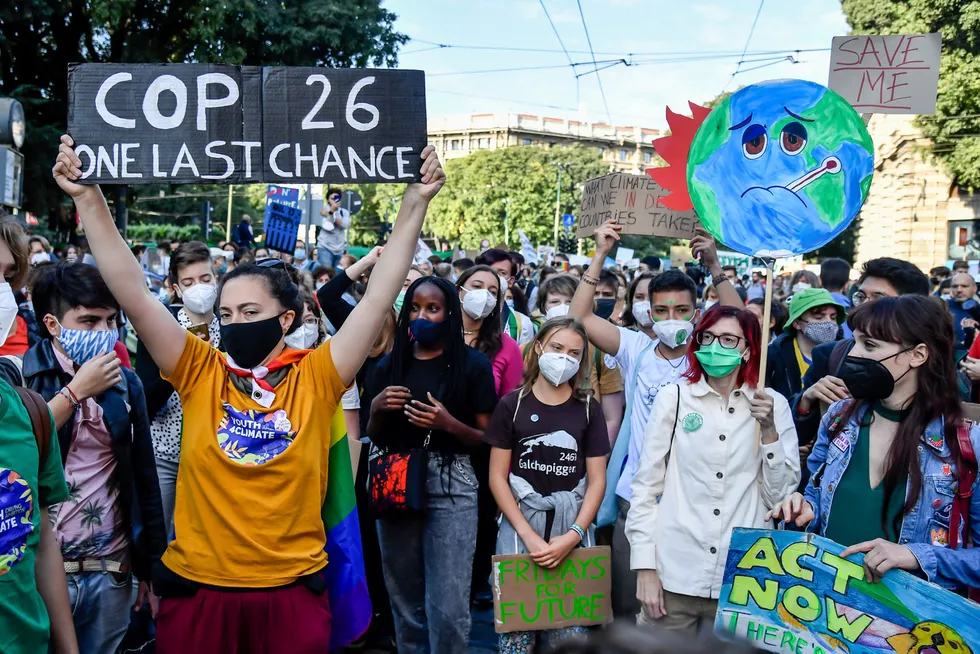 Call to action: Climate activists Vanessa Nakate of Uganda and Greta Thunberg of Sweden, background center, gather with demonstrators during a Fridays for Future protest in Milan, Italy.