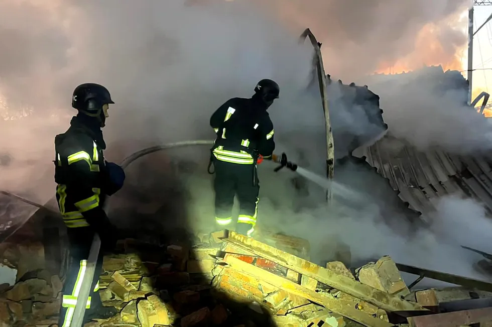 Ukrainian rescuers work to extinguish a fire at an energy infrastructure facility following a missile attack in the country’s Volyn region.