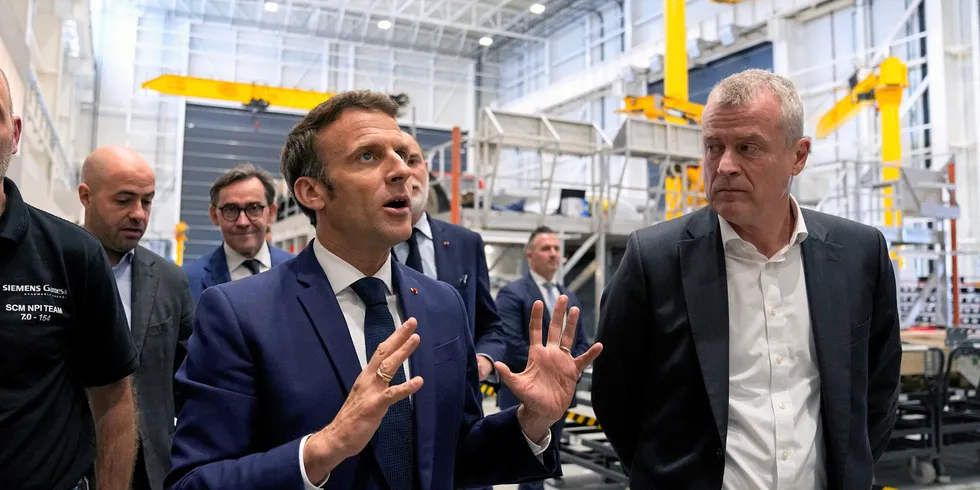 Emmanuel Macron (L) with Siemens Gamesa CEO Jochen Eickholt as he visits the Siemens Gamesa wind turbines factory during a campaign visit to Le Havre, western France, on April 14, 2022.