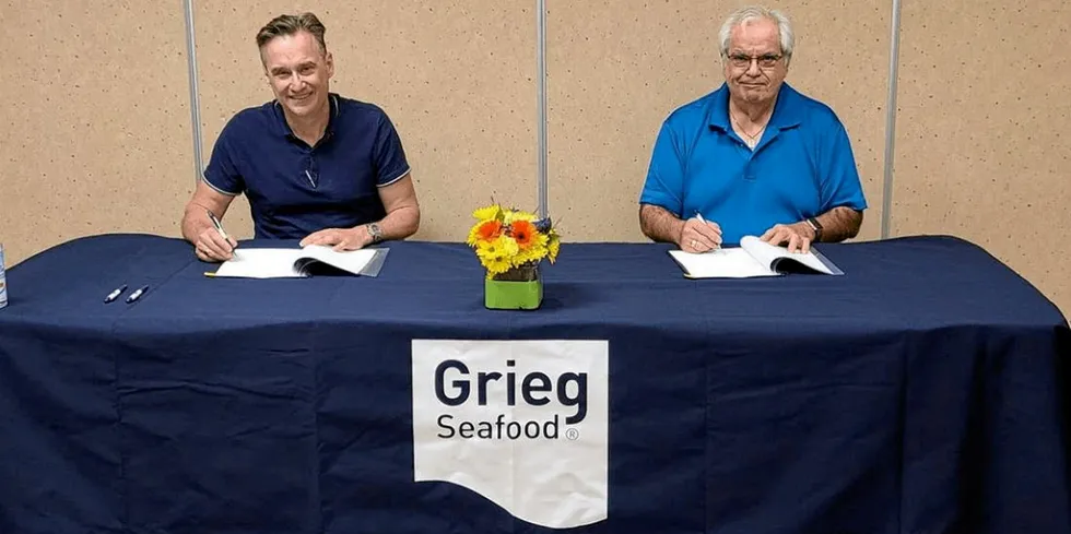 Grieg Seafood’s Managing Director, Rocky Boschman (left) and Tlowitsis Council Member Thomas Smith sign the net-cleaning contract between Grieg and the Tlowitsis Nation.