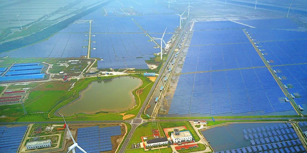 Aerial view of an industrial base consisting of wind turbines, solar panels and fish ponds at tidal flats in Yancheng, Jiangsu Province of China.