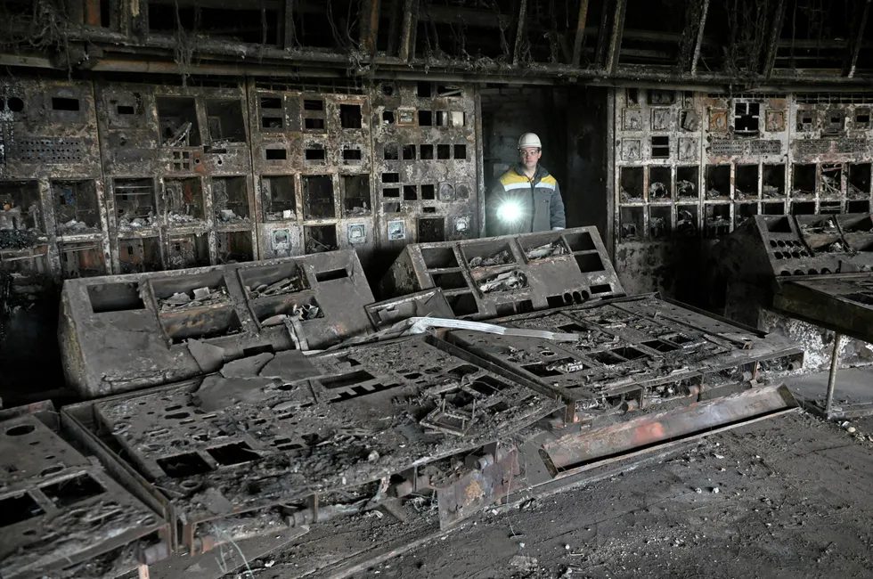 A worker walks through a burned out control room at a power plant of energy provider DTEK, destroyed after an attack, in an undisclosed location in Ukraine on April 19, 2024.