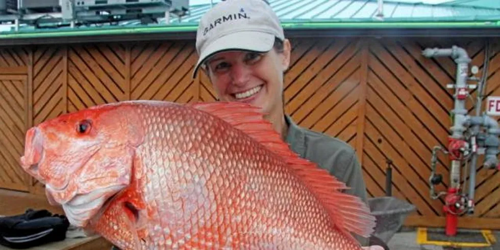 A NOAA scientist holding a red snapper. US fish stocks have shown some signs of recovery, according to a new report.