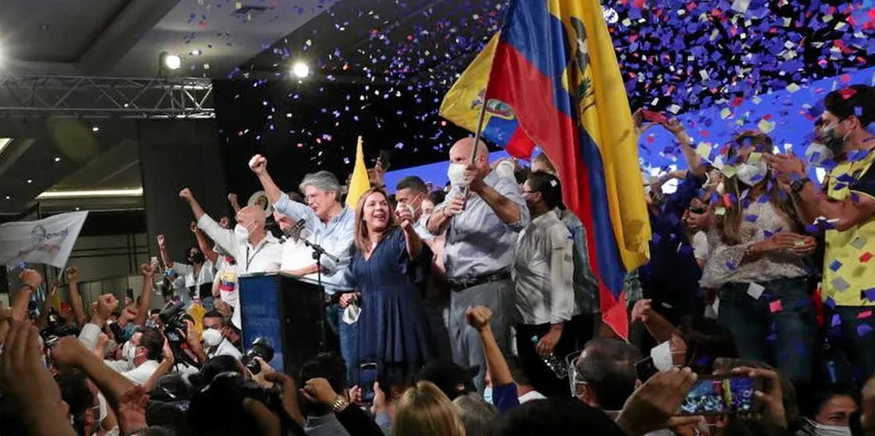 Former banker Guillemero Lasso (arm raised at podium) claimed an unexpected victory in the second round of Ecuador's presidential elections on Sunday.