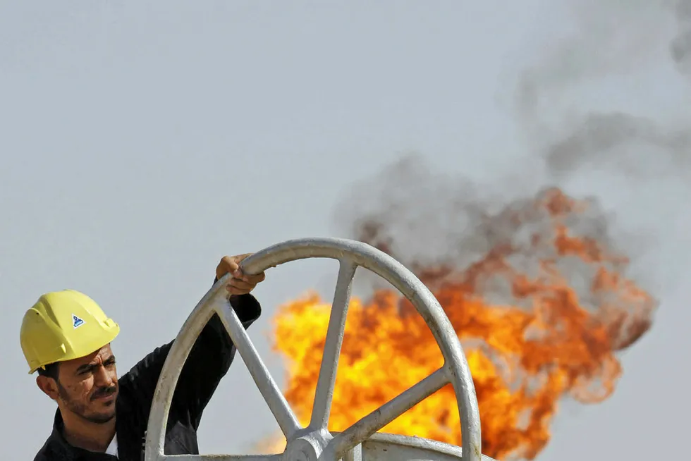 Basra Attack: an Iraqi worker operates valves at the Nahran Omar oil refinery near the city of Basra