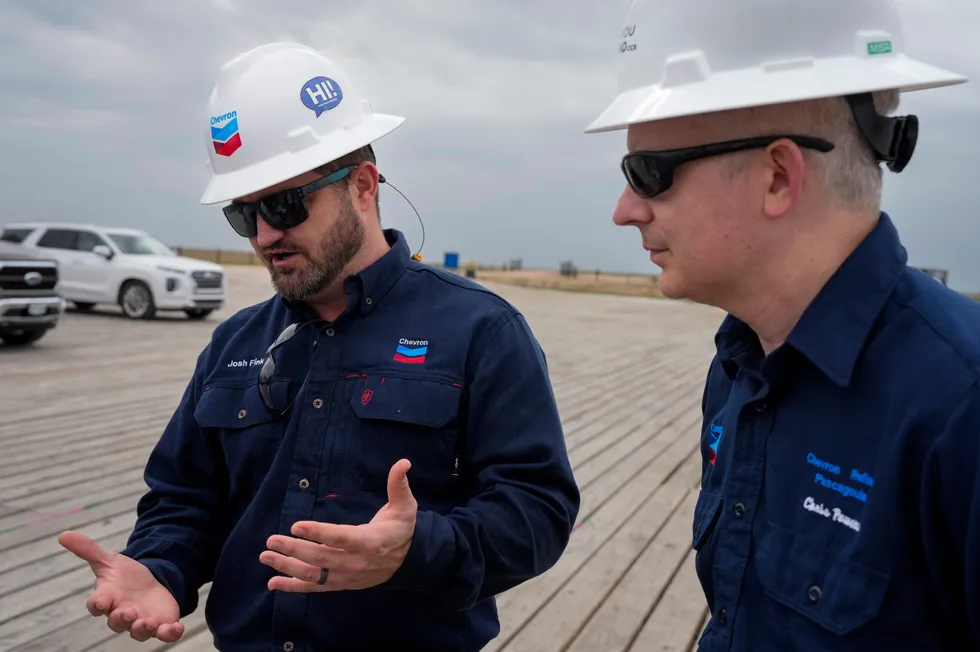 Chevron drilling superintendent Josh Fink (left) explains a standard drilling rig that will be drilling its first onshore test well for the Bayou Bend project while Chris Powers (right), Chevron vice president of CCUS, watches on.