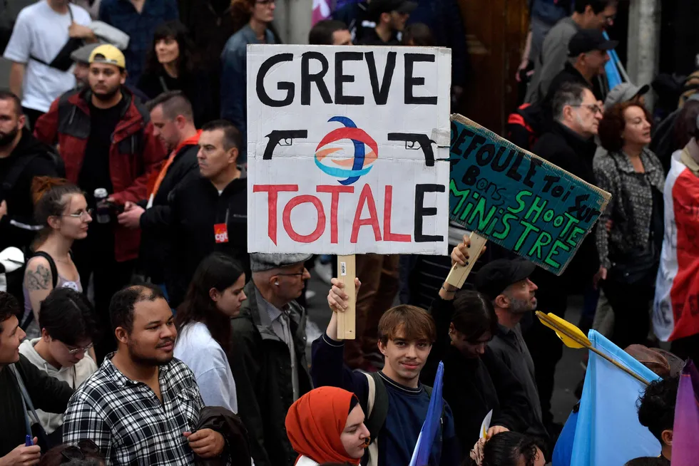 Topshot: a protester holds a placard reading Total strike — a play on the French energy giant TotalEnergies — during a rally against soaring living costs and climate inaction called by France’s New People’s Ecologic & Social Union in Paris last weekend.