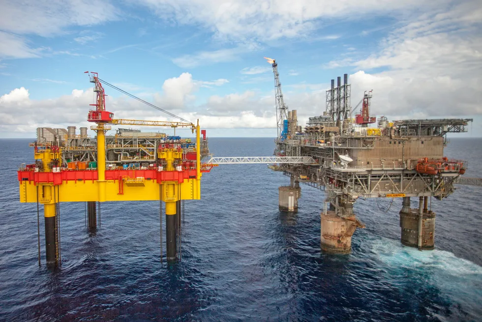 Malampaya phase three included a new depletion compression platform (left) bridge-linked to the existing shallow-water platform.