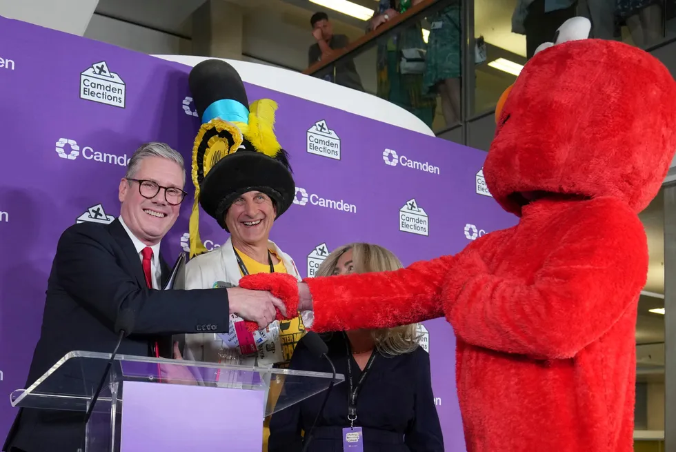Britain's Labour Party leader Keir Starmer (left) shakes hands with other candidates after being elected as member of parliament in the Holborn and St Pancras constituency, in London.