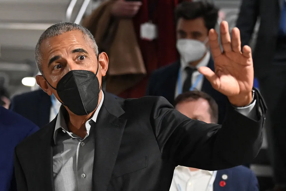 COP26: former US President Barack Obama waves as he walks between sessions during the UN Climate Change Conference on 8 November