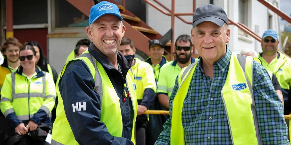 Tassal CEO Mark Ryan (left) shakes on the deal with Cooke CEO Glenn Cooke.