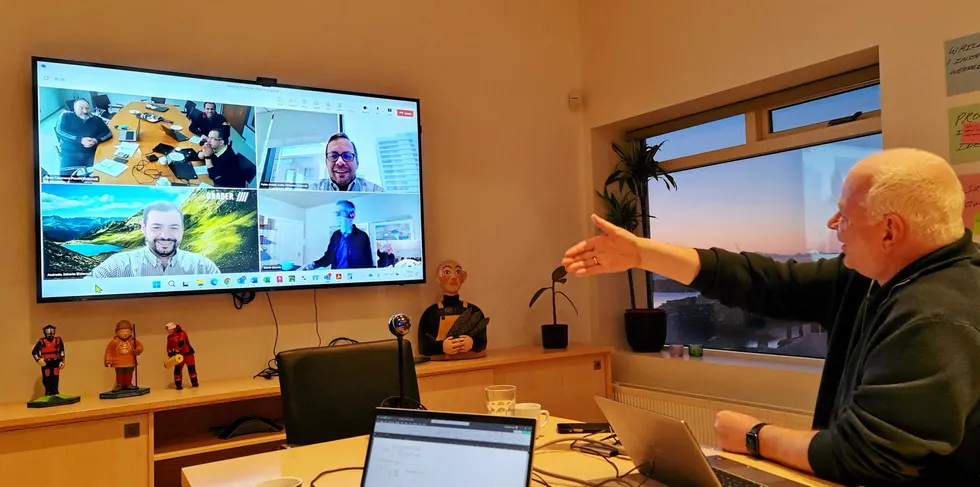 Executives at Chilean seafood processor Friosur and equipment maker Skaginn 3X perform a virtual handshake to seal a deal between the two companies.