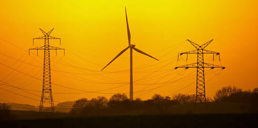 High voltage power grid and wind turbine in Germany.