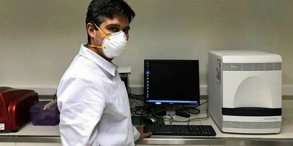 A team of biochemical researchers and professionals from University of Concepción accept polymerase chain reaction (PCR) testing kits and equipment from Cargill to test for SARS CoV-2, the cause of COVID-19.