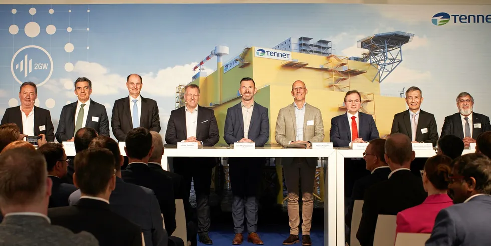 Executives from the winning consortia sign the $33bn of deals with TenneT.