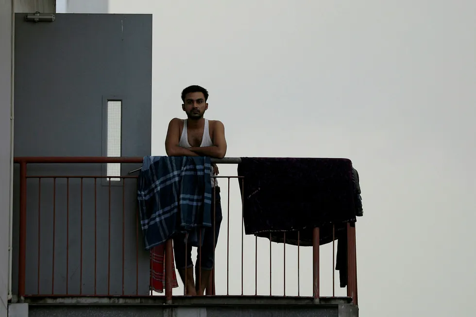 Lockdown: a migrant worker outside his room in a factory-converted dormitory in late May amid the coronavirus pandemic outbreak in Singapore