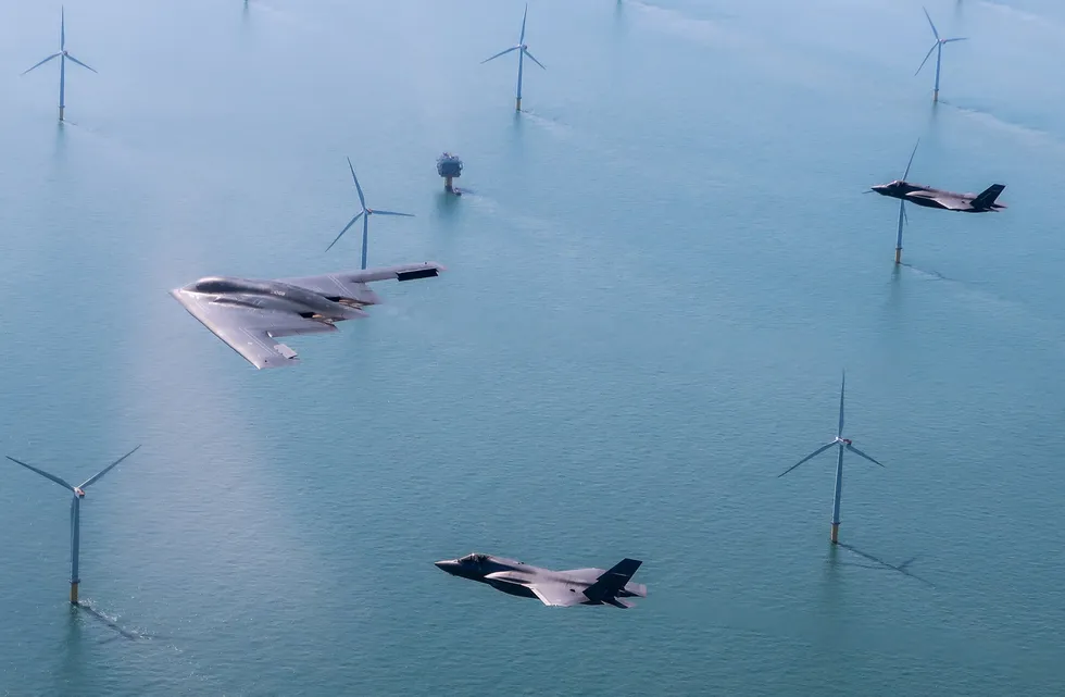 A US Air Force stealth bomber flies above a UK wind farm with two RAF F-35 jets. Stealth technology similar to that used in aircraft could soon be used to reduce the clutter that wind turbines cause military radar systems.