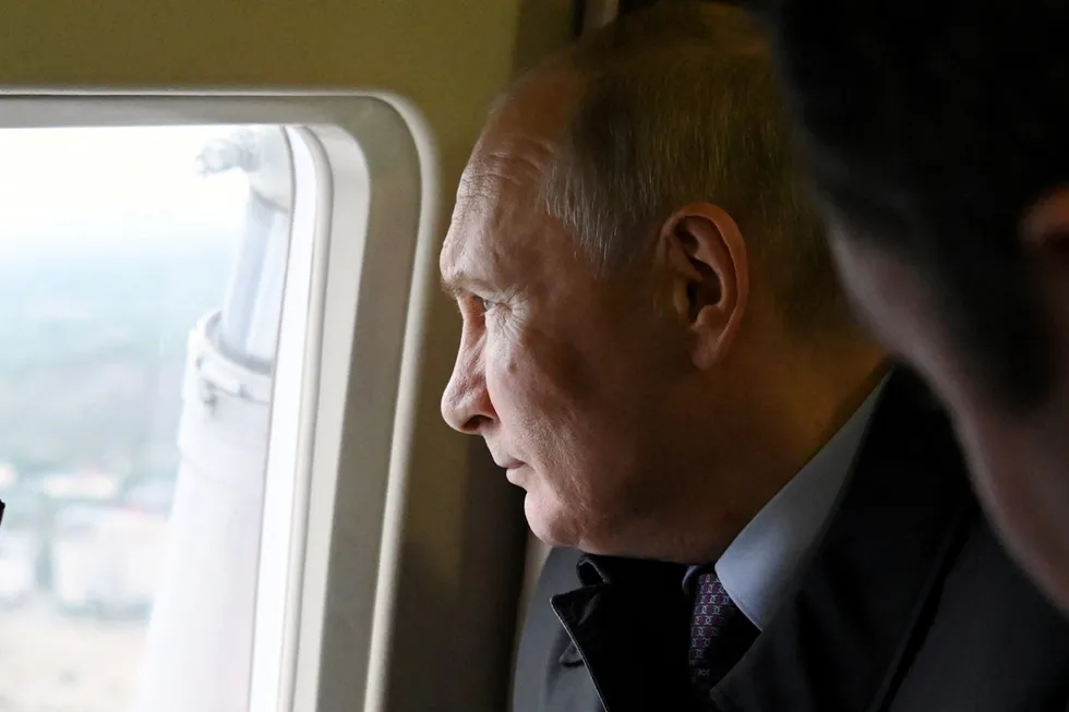 Russian President Vladimir Putin looks through a helicopter window during his flight to the Novatek-operated specialised LNG shipyard in Belokamenka near Russia's port of Murmansk in July 2023.