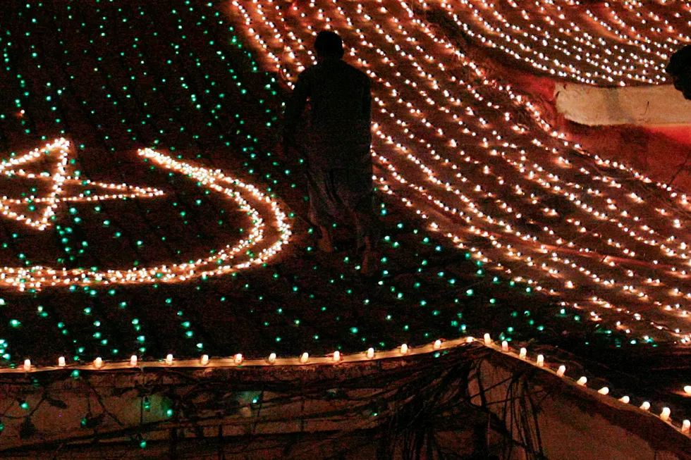 Province: men are silhouetted as they work to illuminate the Balochistan Assembly building