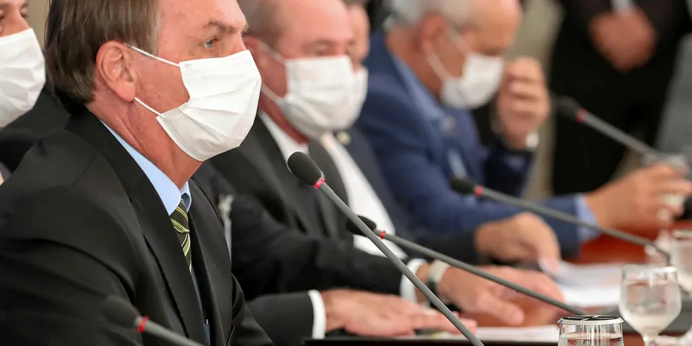 Brazil's far right president Jair Bolsonaro croaked his way through a press conference on Wednesday wearing a surgical mask.