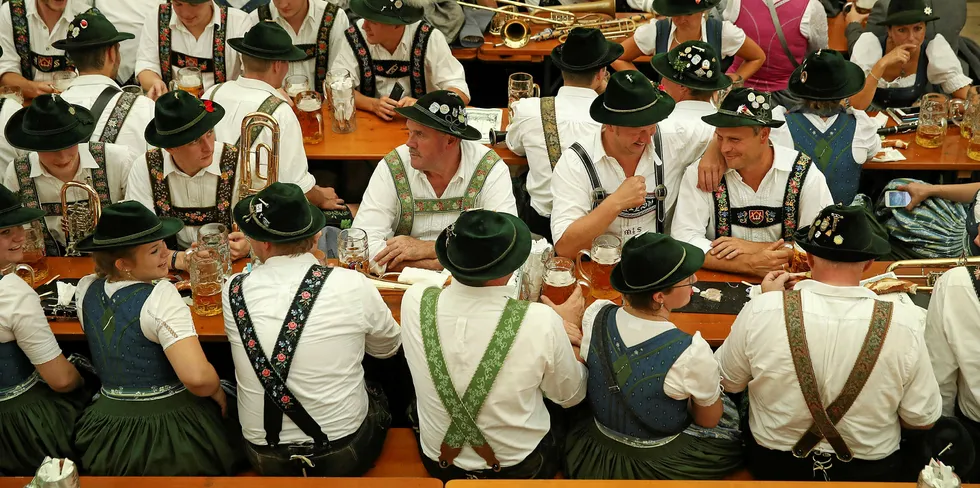 MUNICH, GERMANY - SEPTEMBER 23: Members of a traditional Bavarian marching band drink beer in the Armbrustschuetzenzelt tent following the Oktoberfest parade of costumes of folk and crafts associations.