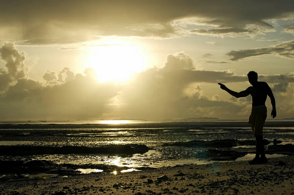 Offshore acreage: a man on the beach in Dar es Salaam, Tanzania