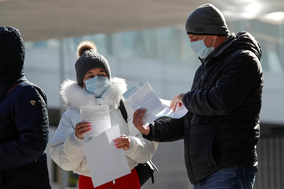 Covid-19 crisis: People gather outside a mobile laboratory for coronavirus disease testing near Saint Petersburg's Pulkovo Airport, Russia