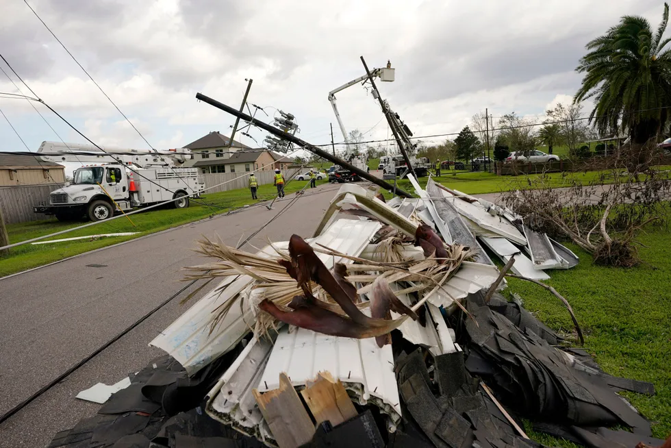 Power down: Crews begin work on downed power lines as residents try to recover from the effects of Hurricane Ida