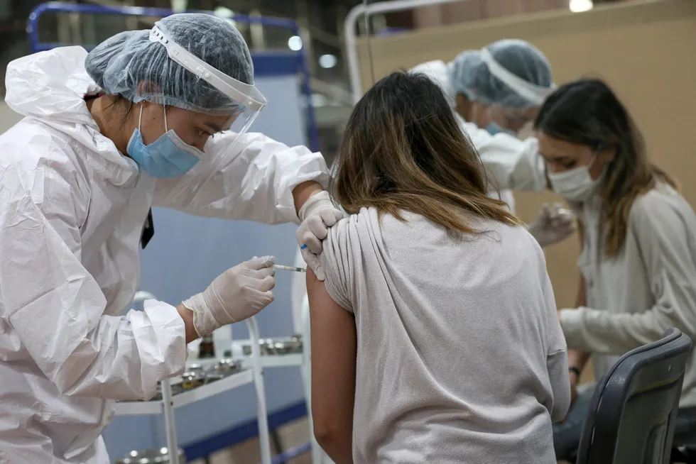 Slow recovery: a woman receives a shot of Russian-made Sputnik V vaccine against Covid-19 in the city of Almaty in Kazakhstan in April 2021