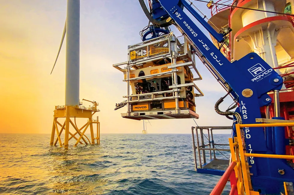 A Rovco vessel services an offshore wind turbine.