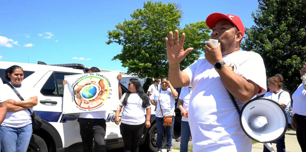 Adrián Ventura, the executive director of Centro Comunitario De Trabajadores, speaks to demonstrators through a speaker outside the True North Seafood company building.
