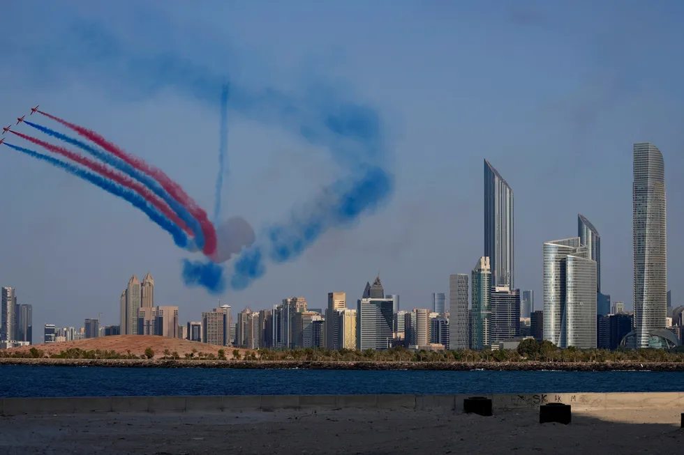 The UK's Royal Air Force Aerobatic Team, the Red Arrows, performs a display over the city skyline in Abu Dhabi, United Arab Emirates.