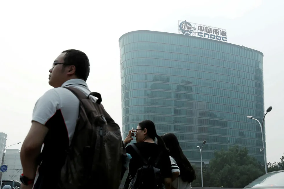 Home-grown technology: people near the headquarters of China National Offshore Oil Corporation in Beijing, China
