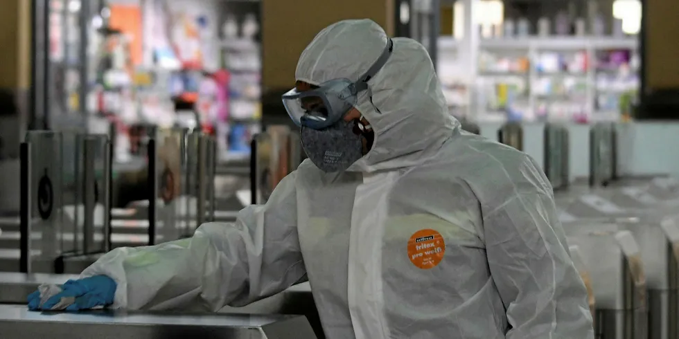 Worker disinfecting suburban train entrance in Spain. The country is among the hardest-hit from the coronavirus pandemic in Europe