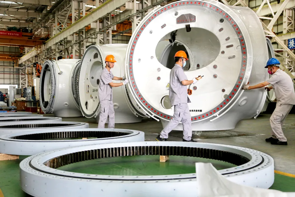 Employees work on a production line of wind turbines at a plant of United Power Technology (Lianyungang) Co.