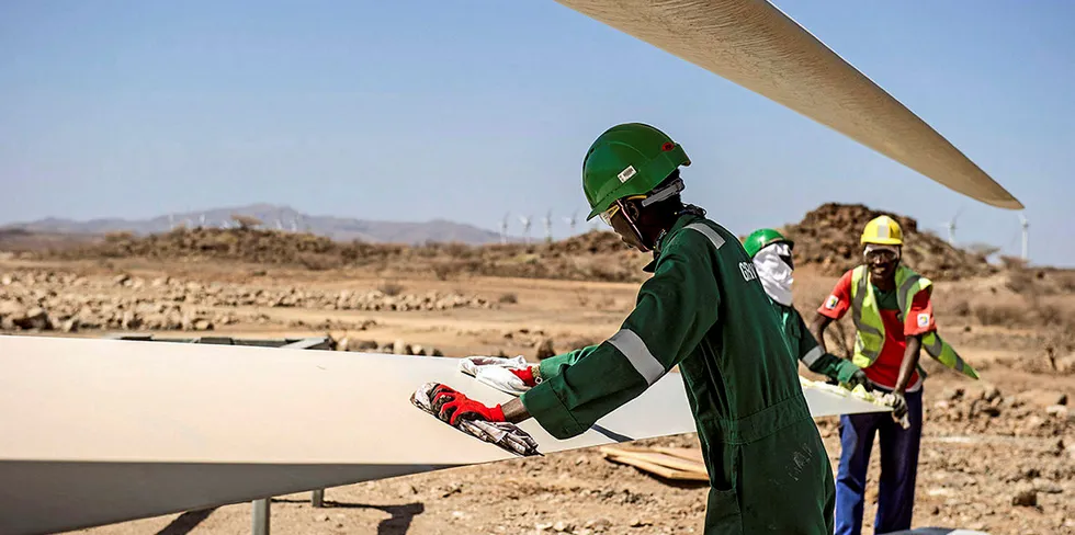 Workers cleaning turbine blades at Lake Turkana wind farm.